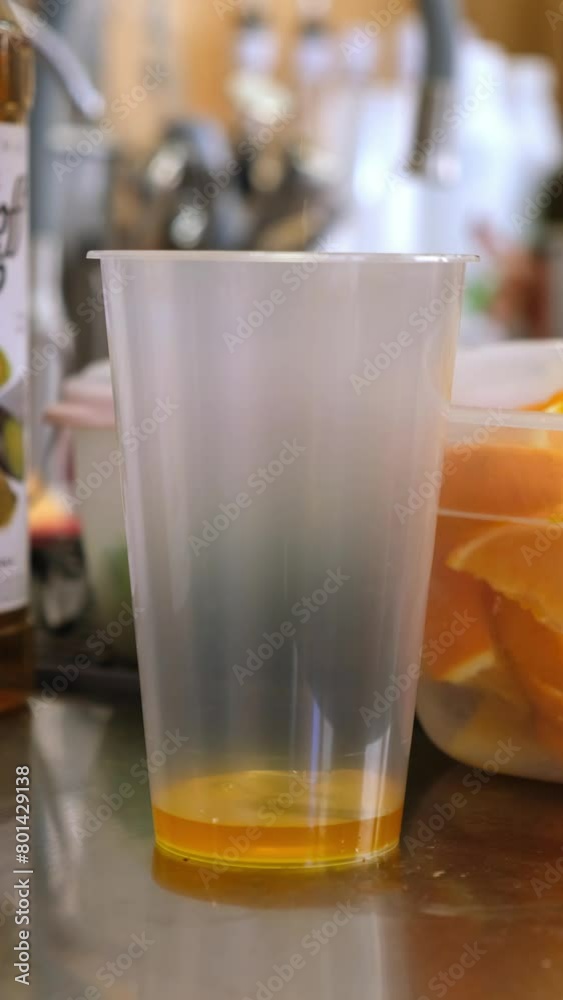 Lemonade with oranges and lemons. The hostess prepares summer soft drinks, cold sweet and sour orange juice is poured into a glass with sliced fresh lemons and oranges. Refreshing summer drink. Lemonade with oranges and lemons. The hostess prepares summer soft drinks, cold sweet and sour orange juice is poured into a glass with sliced fresh lemons and oranges. Refreshing summer drink.