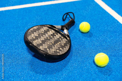 paddle tennis racket and balls on court, 