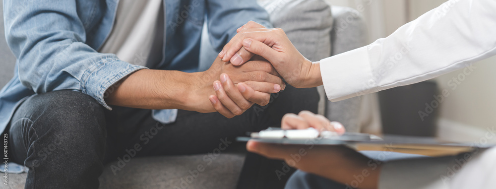 Psychology, depression. Sad asian young man consulting with psychiatrist while patient counseling mental therapy problem with doctor at clinic. Psychologist encouraging with sick mental health person.