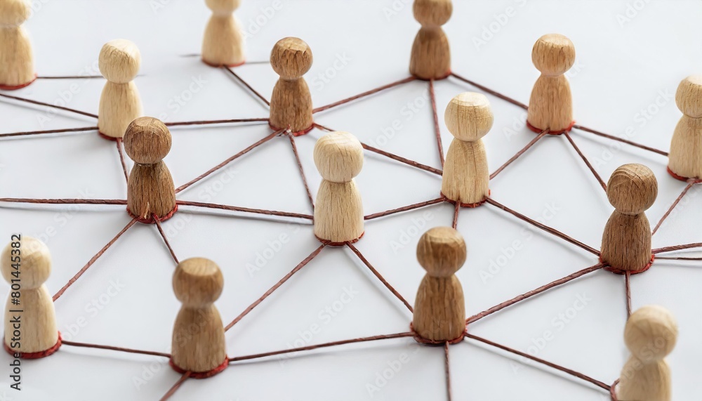 Fototapeta premium group of wooden people are connected by strings, forming a network. Concept of interconnectedness and collaboration, as the people are all linked together