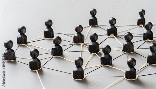 group of wooden people are connected by strings, forming a network. Concept of interconnectedness and collaboration, as the people are all linked together