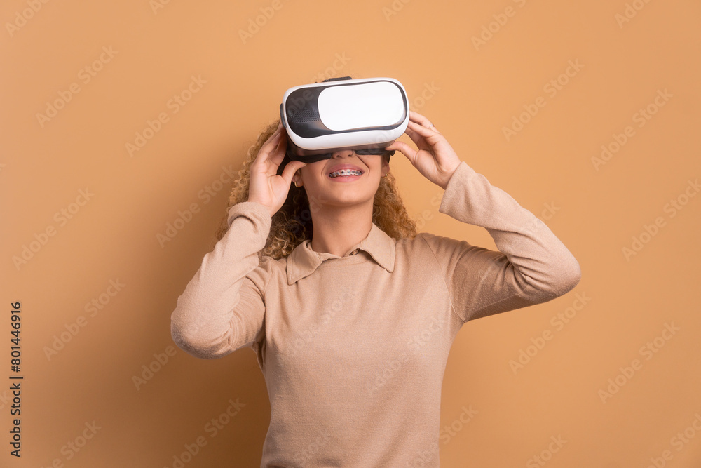 happy caucasian woman Using VR headset and gesturing in beige colors. virtual reality, technology simulation concept. happy caucasian woman Using VR headset and gesturing in beige colors. virtual reality, technology simulation concept.