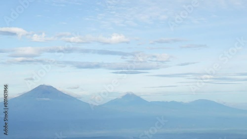 Time Lapse of Mount Sumbing, Mount Sindoro, Mount Prau from the top of Mount Andong photo