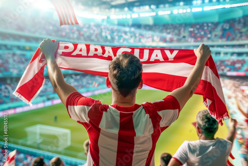 Paraguayan football soccer fans in a stadium supporting the national team with scarfs and flags, Los Guaranies 