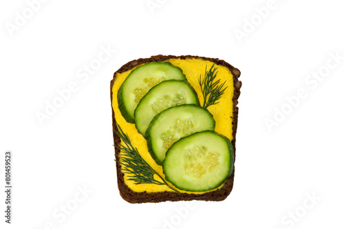 sandwich with cucumbers and yellow sauce on a white background. an appetizing vegetable sandwich on a light background  © Григорий Юник