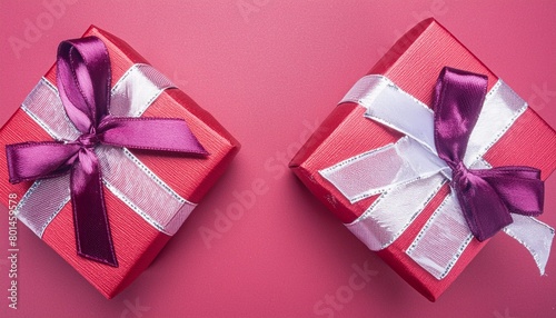 two red gift boxes on red background flat lay present box top view