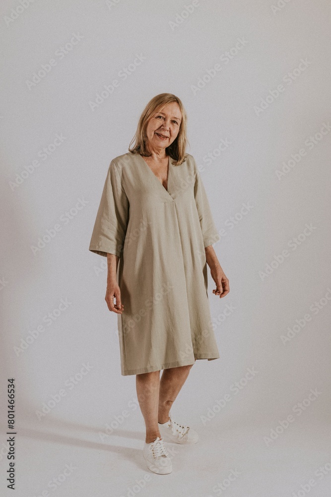 Fototapeta premium Mature woman wearing linen dress, minimal fashion