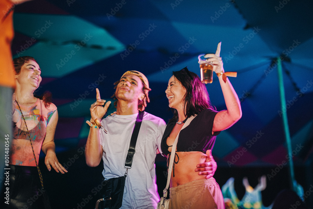 © Jacob Lund - Living the life of the party: Friends celebrating and having fun at a music festival