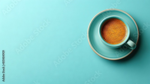  Close-up of blue coffee mug on white saucer with spoon inside photo