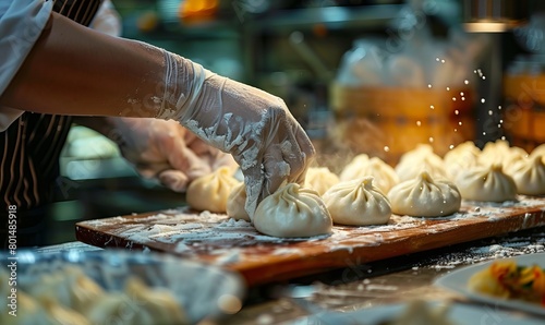 A chef's hands shaping pork bao in the kitchen photo