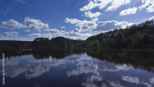 Blue tonal landscape with clouds reflected in water