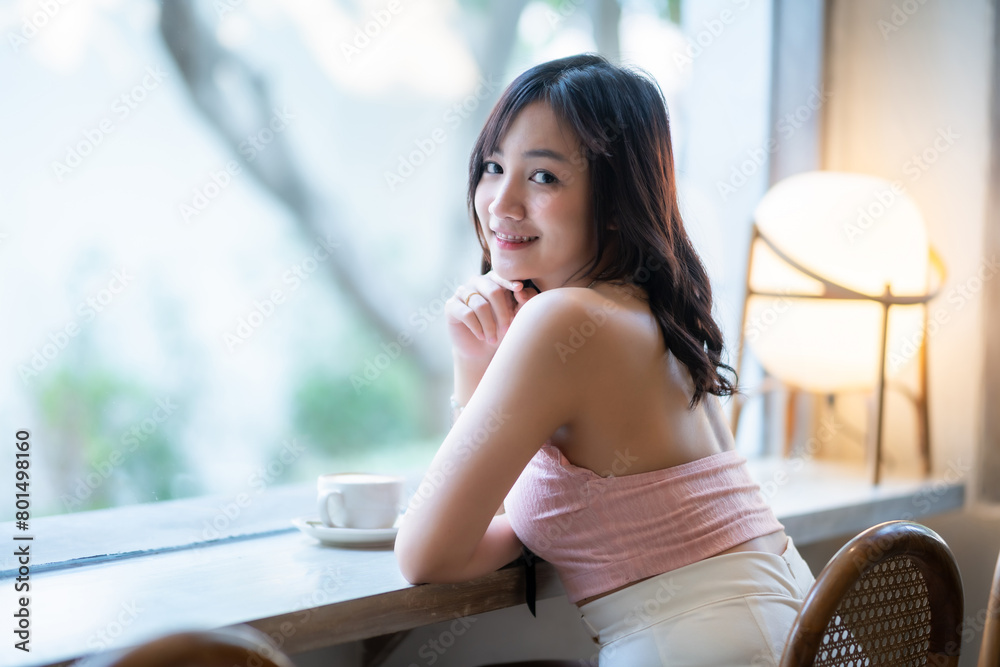Portrait of beautiful happy Smiling asian woman relaxing sitting in cafe interior in coffee shop background,Business Lifestyle summer holiday concept Portrait of beautiful happy Smiling asian woman relaxing sitting in cafe interior in coffee shop background,Business Lifestyle summer holiday concept