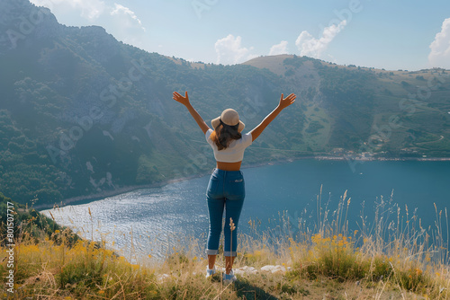 Happy woman standing with her back in nature in summer with open hands posing with mountains. Woman in the mountains, eco friendly, summer landscape active rest