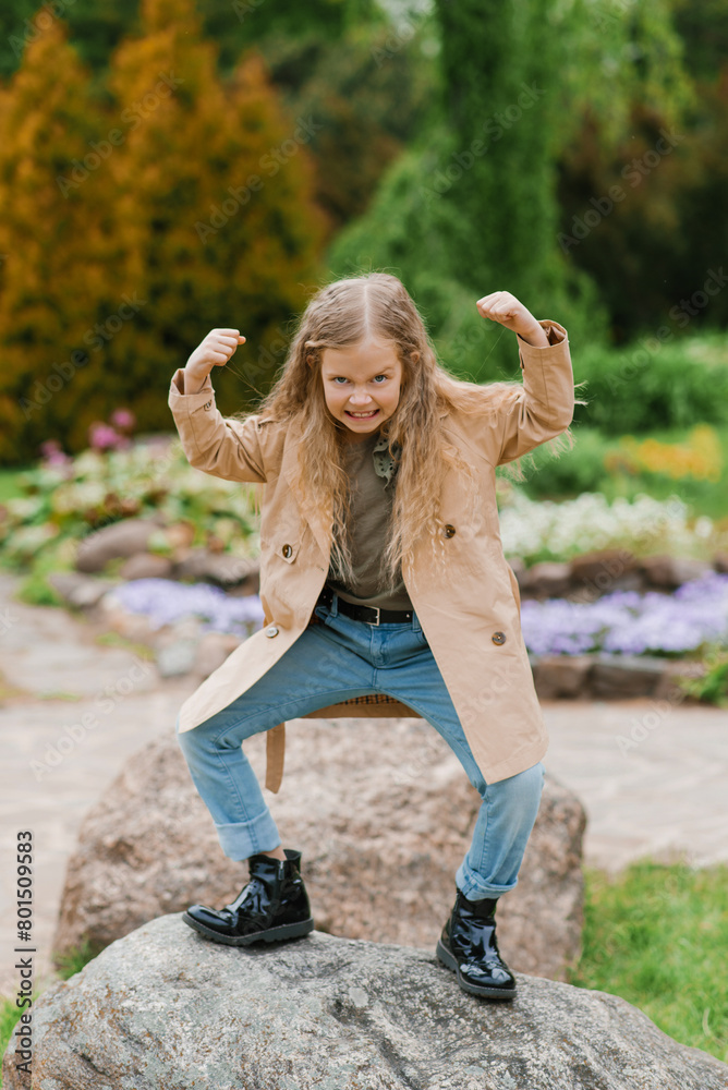 Seven year old girl makes faces in the spring in the park Seven year old girl makes faces in the spring in the park