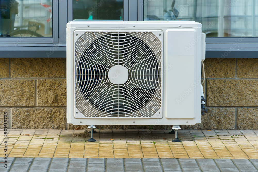 Outdoor air conditioning unit. A large modern air conditioner on the wall of an apartment building. Repair and maintenance of the air conditioning system Outdoor air conditioning unit. A large modern air conditioner on the wall of an apartment building. Repair and maintenance of the air conditioning system