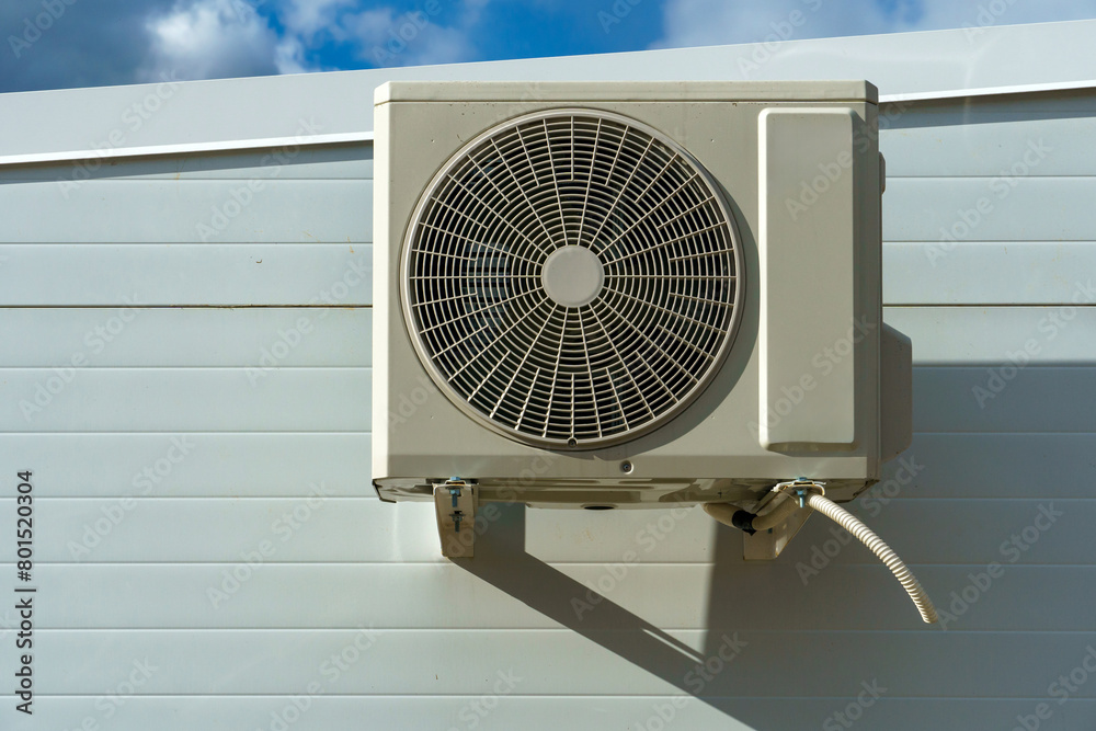 Outdoor air conditioning unit. A large modern air conditioner on the wall of an apartment building. Repair and maintenance of the air conditioning system Outdoor air conditioning unit. A large modern air conditioner on the wall of an apartment building. Repair and maintenance of the air conditioning system