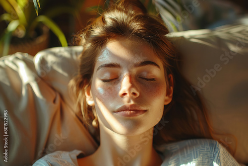 Calm millennial woman relaxing on soft comfortable sofa meditating or having daytime nap