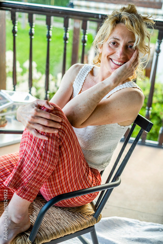 young mature woman relaxing at home on the porch.