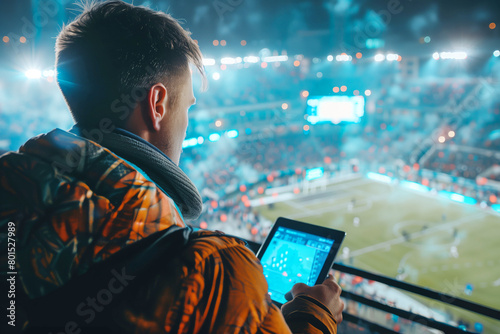 Football fan with tablet at stadium. 5G changing sports experience