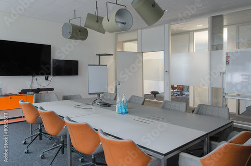 Conference room flipchart whiteboard long table chairs lamps soffits ceilling