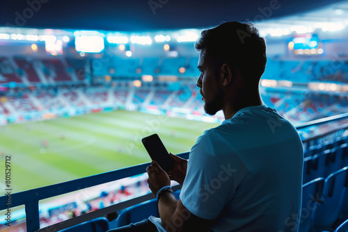 Football fan at stadium with smartphone. 5G revolutionizes sports