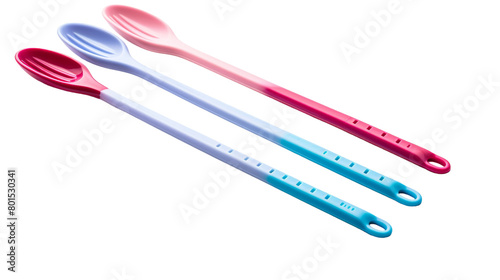 Three spoons and a fork arranged neatly on a white surface