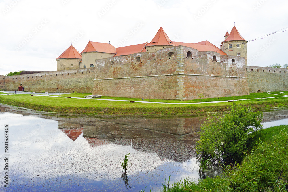 Fototapeta premium Romanian fortress Fagaras and its reflection in the waters of the moat