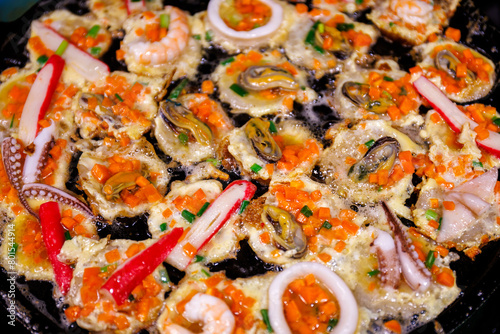 Thai-style takoyaki with mussels seafood shrimp and squid in hot pan