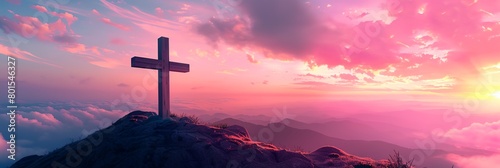 a cross on a hill with a sunset in the background and clouds in the sky above it photo