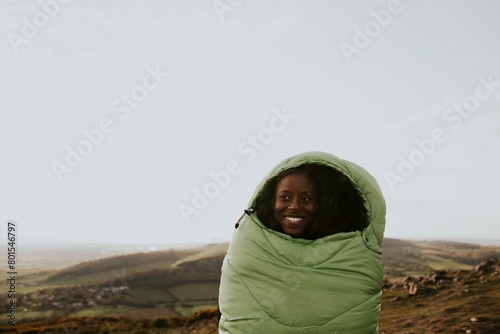 Smiling woman in sleeping bag jacket, apparel photo