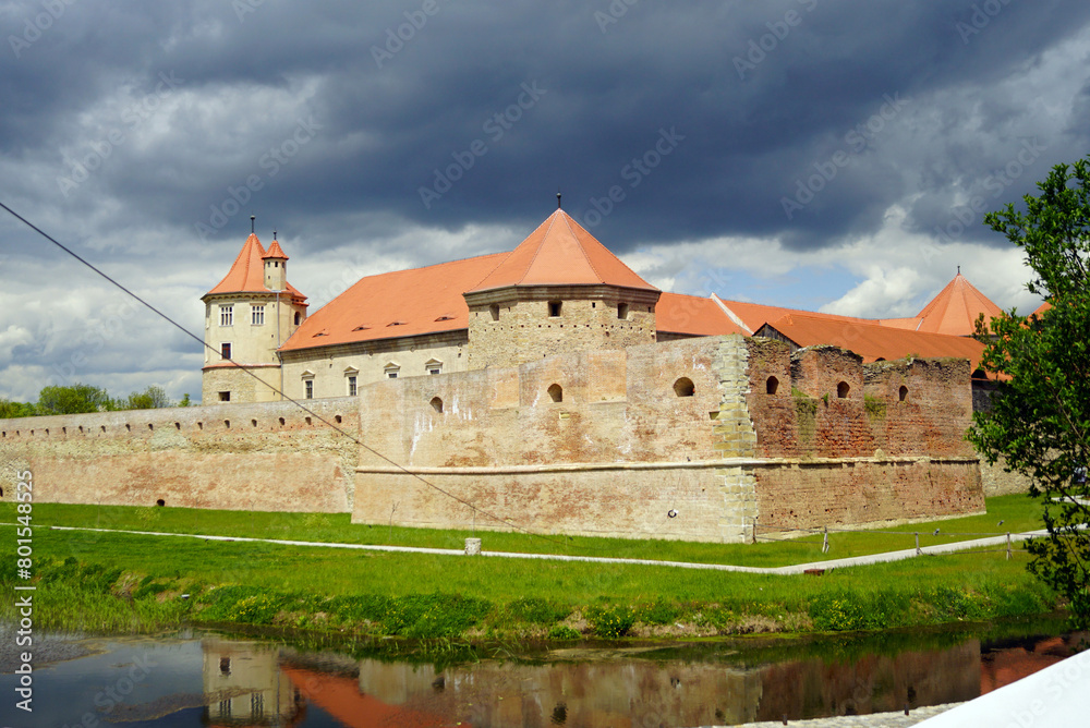 Fagaras fortress and the moat in front of it against the backdrop of a stormy sky (Brasov County, Romania) Fagaras fortress and the moat in front of it against the backdrop of a stormy sky (Brasov County, Romania)