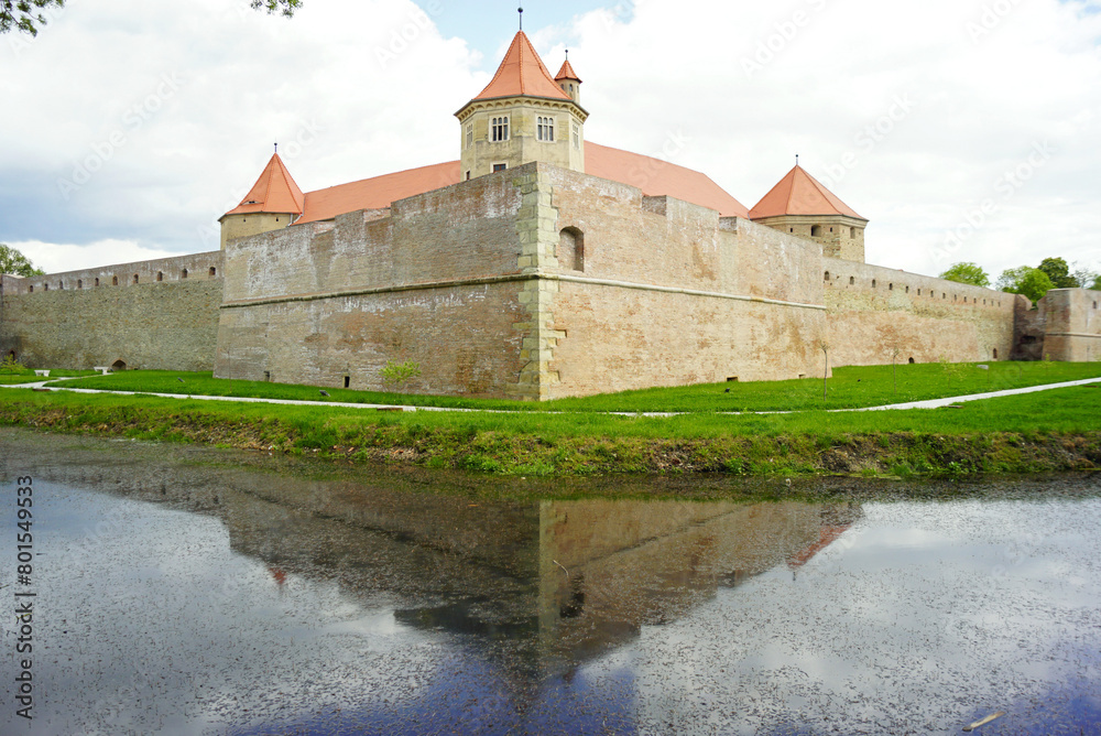 Transylvanian fortress Fagaras - view from the corner. The ancient defensive walls and towers of the palace are behind them. Transylvanian fortress Fagaras - view from the corner. The ancient defensive walls and towers of the palace are behind them.
