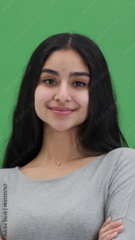 Portrait of a carefree and cheerful Indian woman on green background. Simplicity, elegant, difference people concept. Vertical video. Portrait of a carefree and cheerful Indian woman on green background. Simplicity, elegant, difference people concept. Vertical video.
