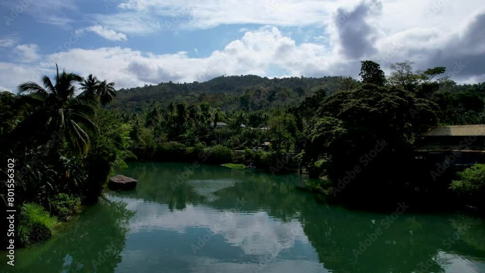 4K Aerial drone video of emerald Loboc river with riverside road and houses and sheds in Bohol, Philippines 4K Aerial drone video of emerald Loboc river with riverside road and houses and sheds in Bohol, Philippines