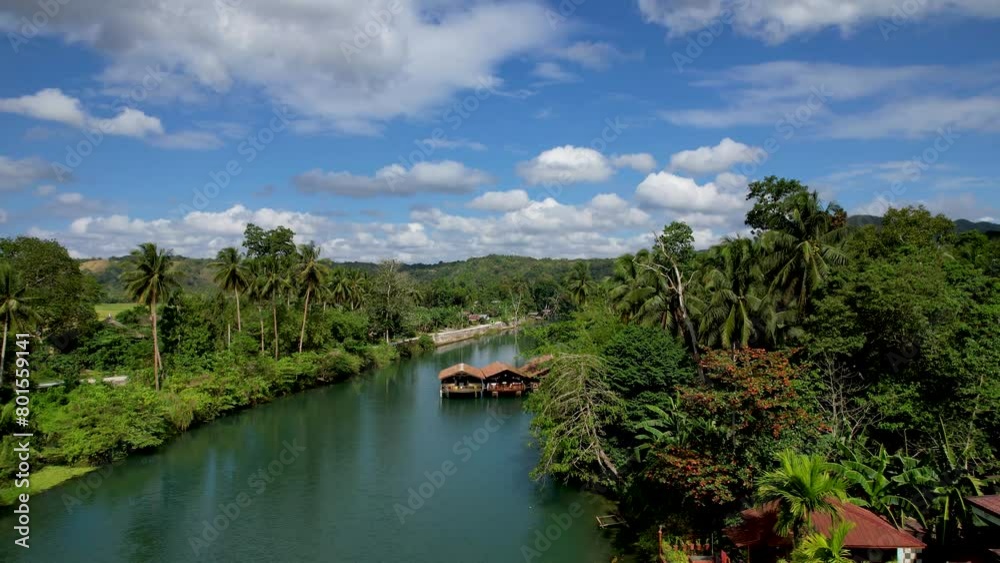 4K Aerial drone video of emerald Loboc river with riverside road and houses and sheds in Bohol, Philippines 4K Aerial drone video of emerald Loboc river with riverside road and houses and sheds in Bohol, Philippines