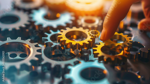 A series of gears and cogs interconnected, with a person's hand initiating movement, depicting the impact of decisions in the operational workflow, decision making, business, natur