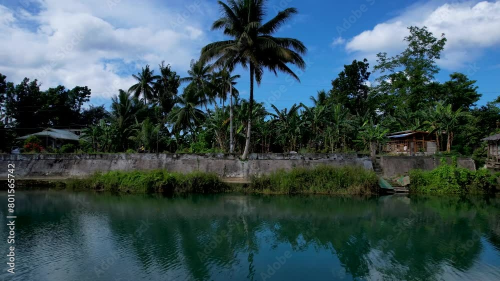 4K Aerial drone video of emerald Loboc river with riverside road and houses and sheds in Bohol, Philippines 4K Aerial drone video of emerald Loboc river with riverside road and houses and sheds in Bohol, Philippines