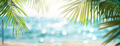 Summer background with tropical palm leaves and sandy beach background banner for summer vacation travel concept