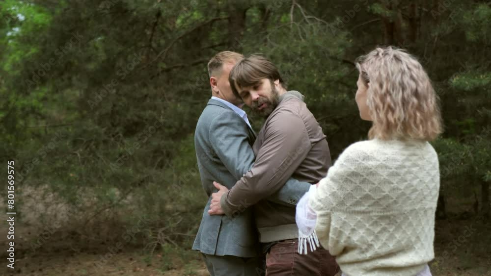The photographer shows the models how to pose correctly. Professional wedding photography in the forest. Behind the scenes. Slow motion The photographer shows the models how to pose correctly. Professional wedding photography in the forest. Behind the scenes. Slow motion