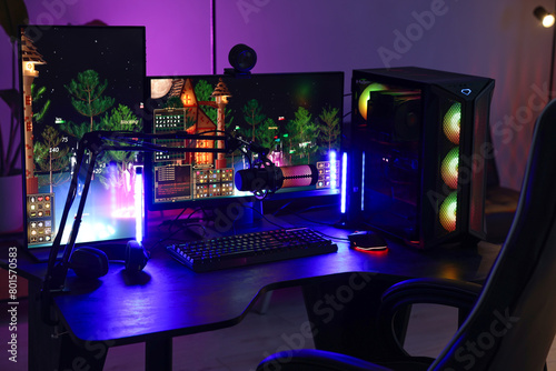 Playing video games. Stylish room interior with modern computer and gaming chair in neon lights