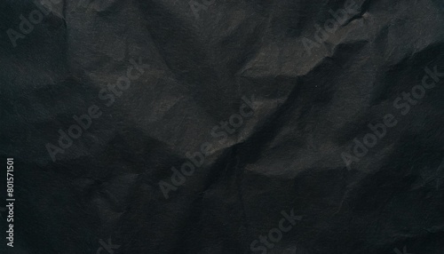 crumpled paper texture black cardboard sheet gloomy background photo