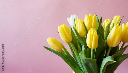 little girl holding a bouquet of tulips in front of a pink background