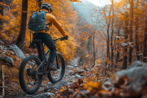 Mountain biker explores rocky autumn trail © gearstd