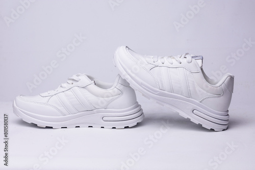 Women's white sneakers on a white background