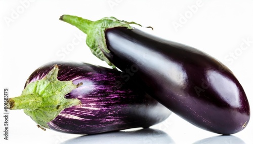 two purple eggplants with green leaves on top