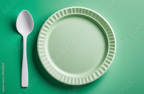 Disposable white biodegradable tableware on a light background