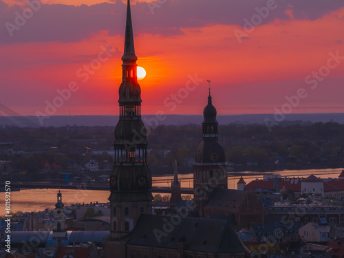 Magical aerial sunset over Riga old town, the capital of Latvia. Riga rooftop view panorama at sunset with urban architectures and Daugava River.
