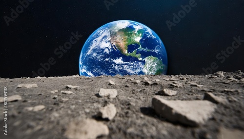 blue planet earth from a crater on the moon s surface