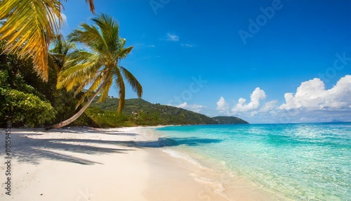 travel beach concept pristine white sand meets a tranquil sea bay under a sunlit blue sky featuring exotic paradise vibes from the mediterranean to the tropics with green palm trees generative ai