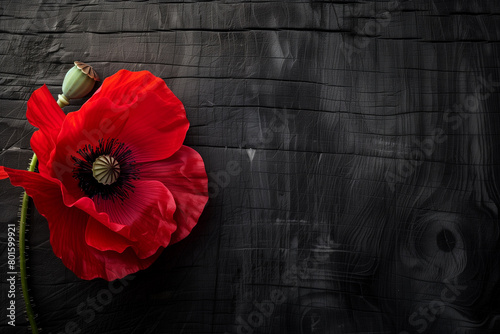 Remembrance Red Poppy Pin on Dark Wooden Texture Honoring Anzac Day Commemorations photo